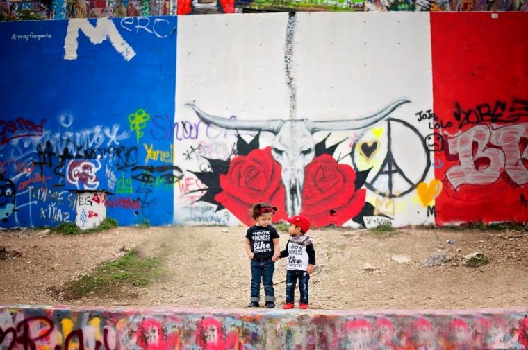 “My 2-year-old Milah & her little friend showing love from Austin, Texas. This mural was painted last Saturday night. Their shirts read, 'Throw kindness like confetti.'"