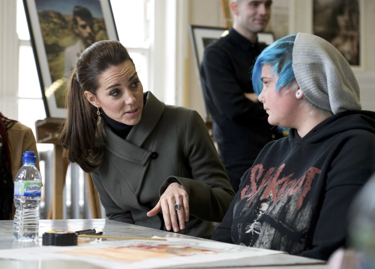 Duchess of Cambridge speaks to young people as she visits a photographic exhibition