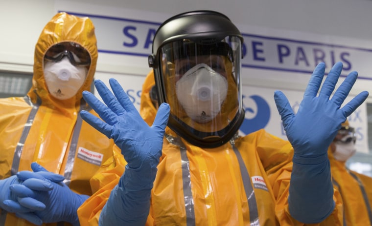 Image: Staff wearing Ebola protection outfits at Necker Hospital in Paris on Oct. 24, 2014