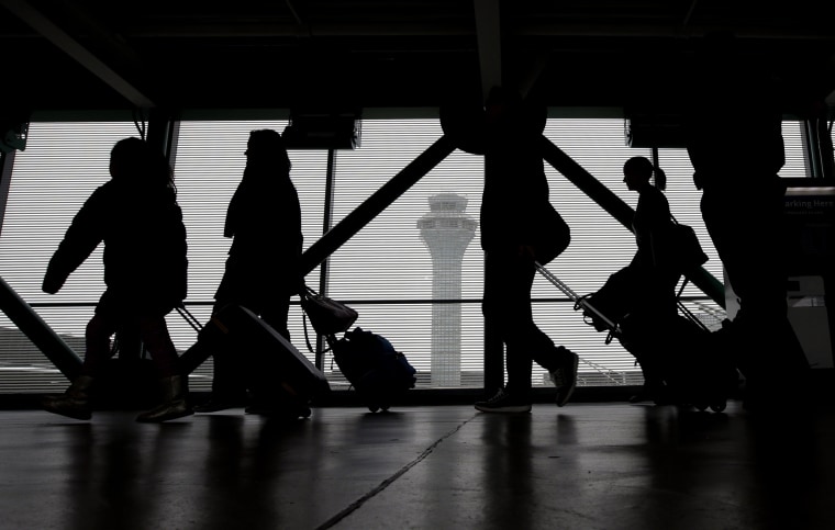 Image: Passengers walk through Terminal 3 at O'Hare International Airport