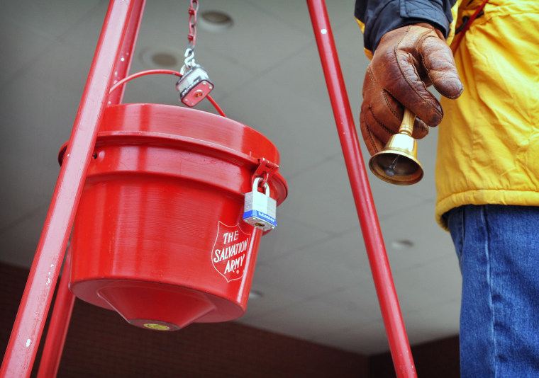 Image: A man rings a bell at a Salvation Army donation kettle