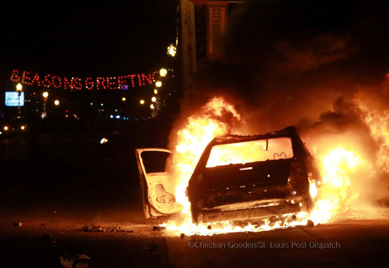A St. Louis County Police car sits ablaze in the 300 block of South Florissant Road on Monday Nov. 24, 2014, during a night of protests in Ferguson following a grand jury decision not to indict Darren Wilson for the shooting death of unarmed teen Michael Brown in August. Photo by Christian Gooden, St. Louis Post-Dispatch