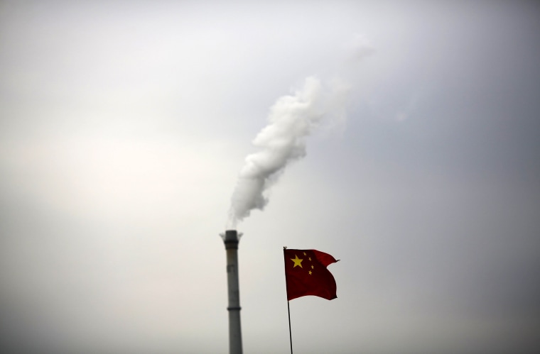 Image: File photo of China's national flag being seen in front of a chimney of a cogeneration plant in Beijing