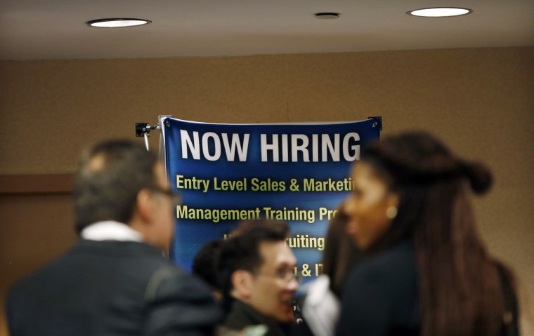 Image: Job seekers wait to meet with employers at a career fair in New York City