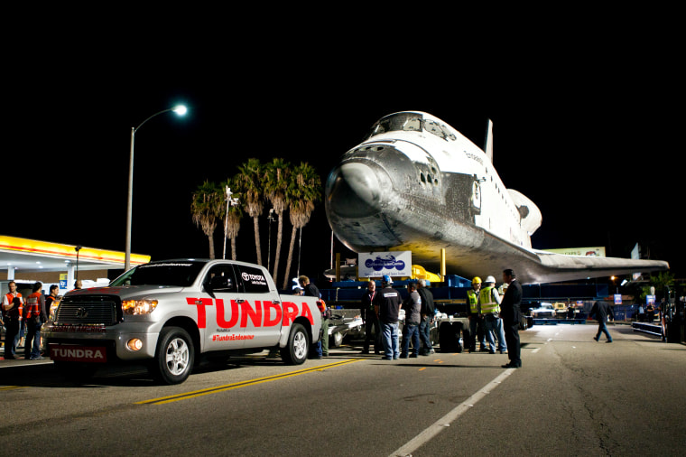 Space shuttle Endeavour is towed by a Toyota Tundra pickup on Oct. 12, 2012.