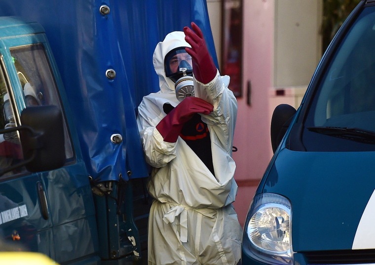 Image: A worker gets dressed in front of Brussels' Great Mosque in Brussels