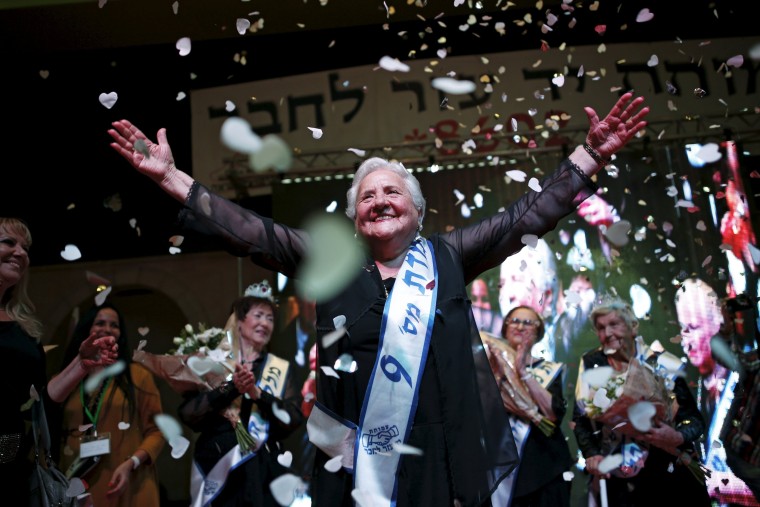 Image: Rita Berkowitz, a Holocaust survivor and winner of a beauty contest for survivors of the Nazi genocide, waves on a stage, in the northern Israeli city of Haifa