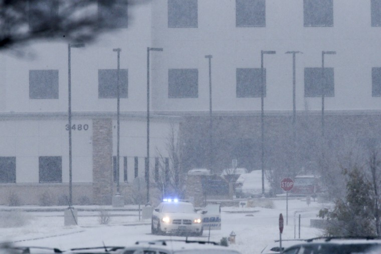 Image: A police vehicle is seen left with the doors open at a Planned Parenthood center at 3480 Centennial Boulevard after reports of an active shooter in Colorado Springs