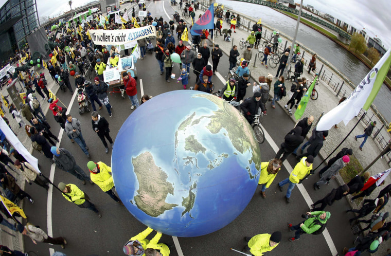 Image: Protesters demonstrate during a rally held the day before the start of the Paris Climate Change Summit in Berlin