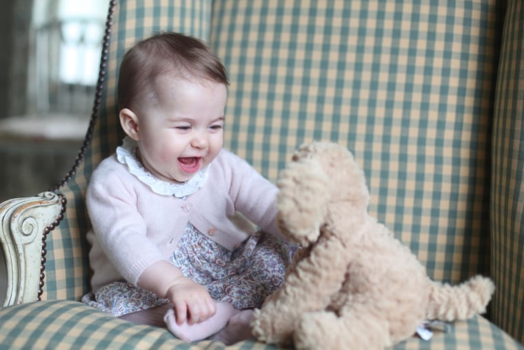 Image: Princess Charlotte playing with a toy dog.