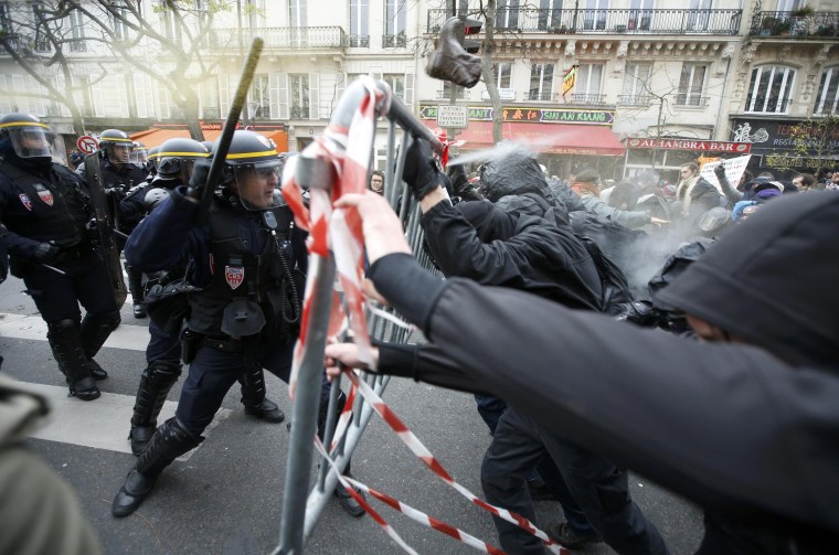 Image: Demonstrators clash with CRS riot policemen near the Place de la Republique after the cancellation of a planned climate march  ahead of the World Climate Change Conference 2015 in Paris