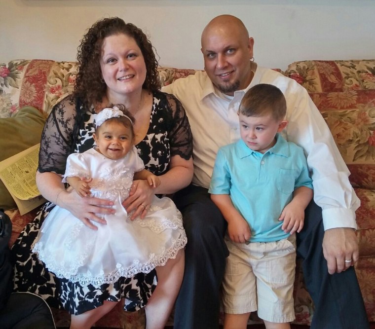 Diane and Chris Walker hold their children Natalia and Frankie.