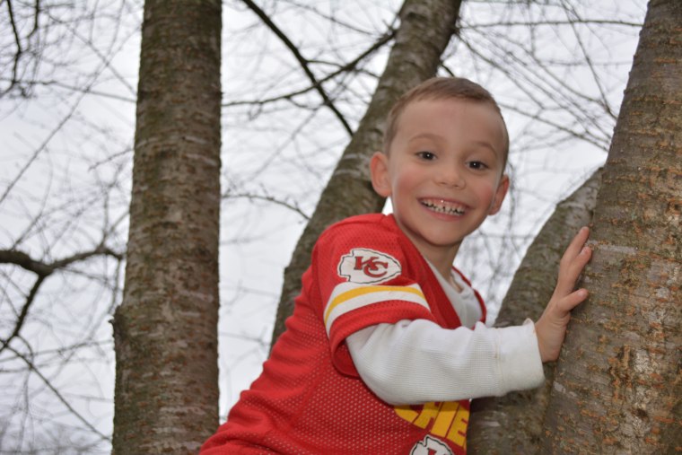 Michael Mosier climbing a tree.