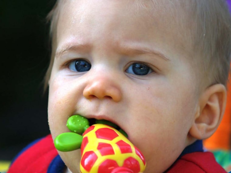 Baby chewing on a toy