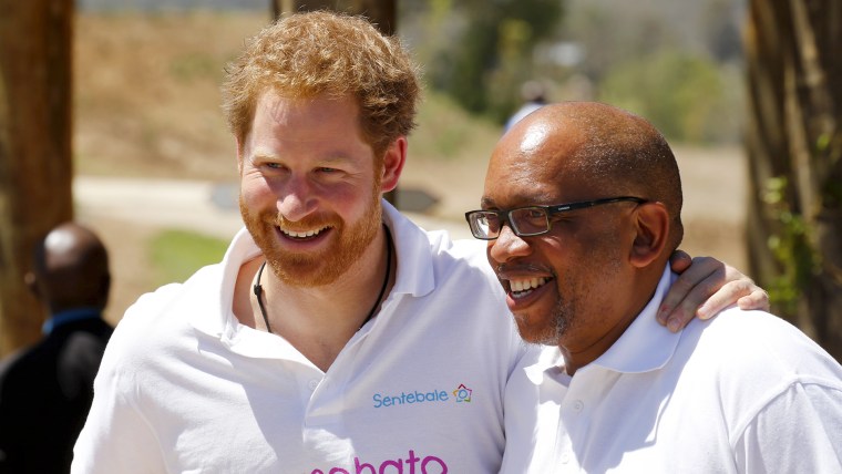 Image: Britain's Prince Harry and Lesotho's Prince Seeiso react during a visit on behalf of Sentebale, the charity they founded, at the Mamohato Children's Centre in Thaba Bosiu