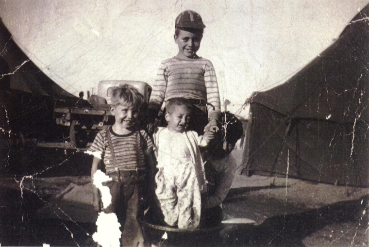 Francisco, left, and his brothers Trampita, and Roberto (wearing a cap), at Tent City in Santa Maria, Calif. Jiménez grew up in an immigrant family of farm workers.