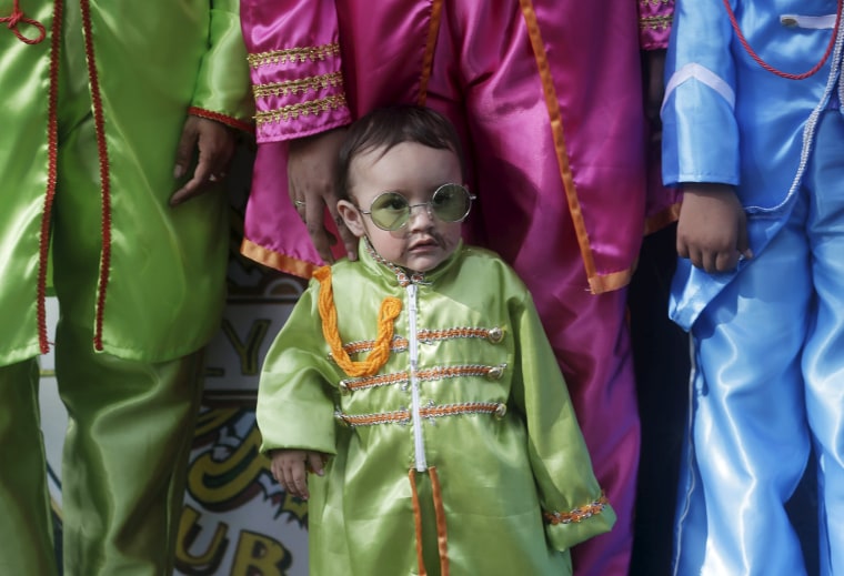 Image: A child dressed as The Beatles takes part in an attempt to set a Guinness World Record for the largest number of people dressed as the British band The Beatles at a park in Mexico City