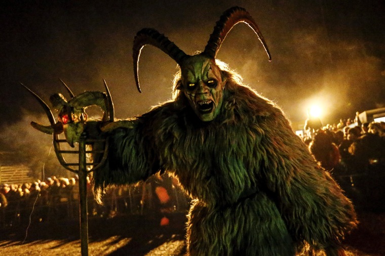 Image: Man dressed in a traditional Krampus costume and mask