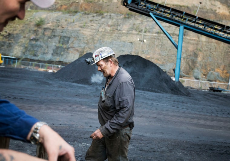 Image: Foreman John Dillon walks past piles of coal