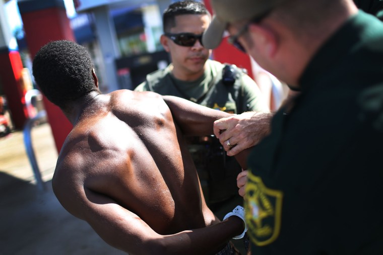 Image: Sgt. Ozzy Tianga and a deputy handcuff a man suspected of being under the influence of flakka