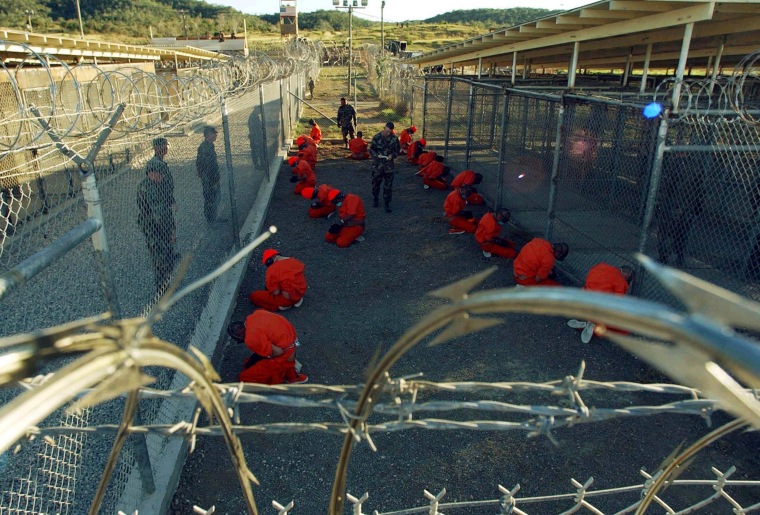 Image: Detainees in orange jumpsuits at Guantanamo Bay