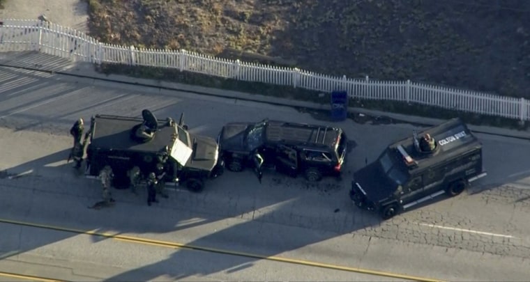 Image: Police armored cars close in on a suspect vehicle following a shooting incident in San Bernardino, California in this still image taken from video