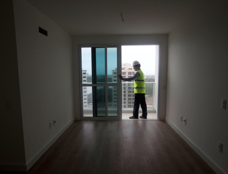 Image: A worker in an apartment unit at the Rio 2016 Athletes Village