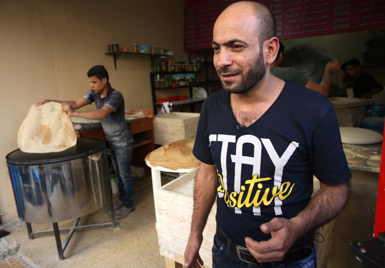 Image: Abdul Halim al-Attar stands outside his bakery in Beirut, Lebanon.