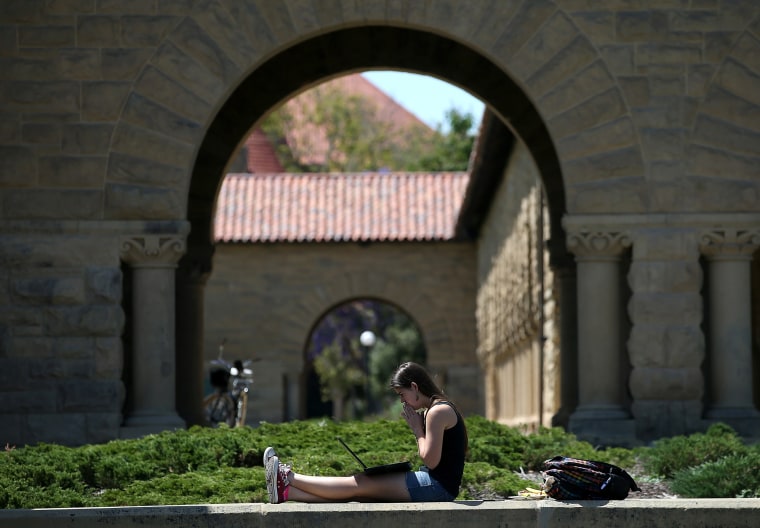 Image: A woman works on a laptop on the Stanford University campus