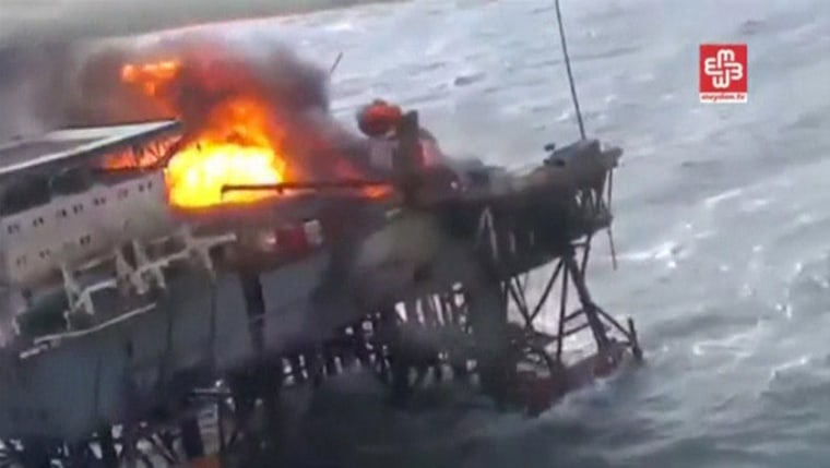 Image: A still image from a video footage shows an oil platform on fire in the Caspian Sea