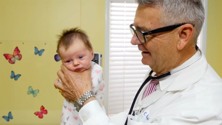 Pediatrician shows a technique to calm a crying baby