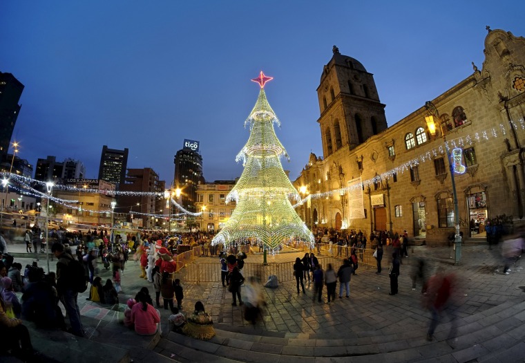 Image: An illuminated Christmas tree is displayed in front of San Francisco church in La Paz