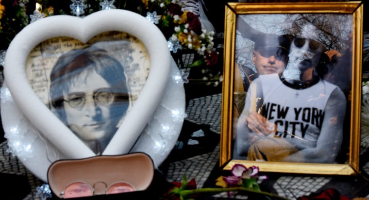 Image: A man is reflected in a picture as people gather and sing songs by John Lennon