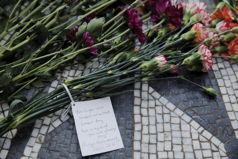 Image: Flowers lay at the Imagine mosaic in the Strawberry Fields section of New York's Central Park to mark the 35th anniversary of John Lennon's death, in New York