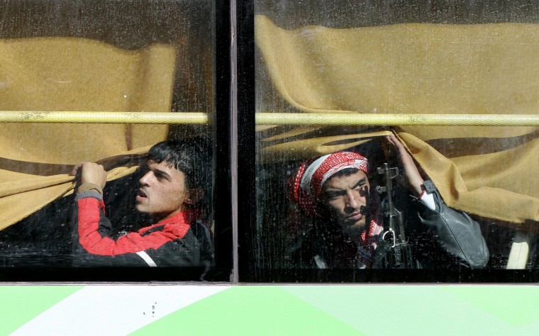 Image: Syrian rebel fighters are seen on a bus