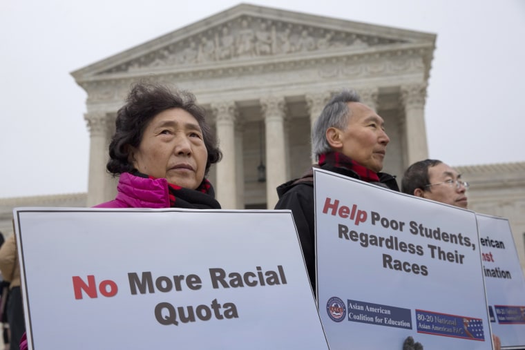 Guixue Zhou of North Potomac, Md., left, and others, protests against racial quotas outside the Supreme Court in Washington
