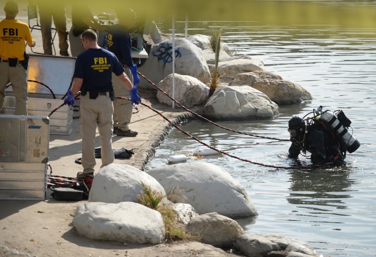 Image: FBI Underwater Search and Evidence Response Team work in Seccombe Lake