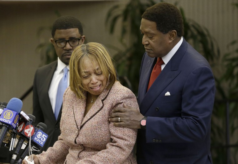 Image: Gwen Woods is comforted by her attorney