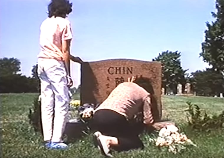 This screenshot from the documentary "Who Killed Vincent Chin?" shows Chin's family at his grave.