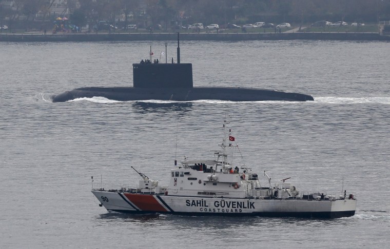 Image: Russia's diesel-electric submarine Rostov-on-Don is escorted by a Turkish Navy Coast Guard boat as it sets sail in the Bosphorus, on its way to the Black Sea, in Istanbul, Turkey