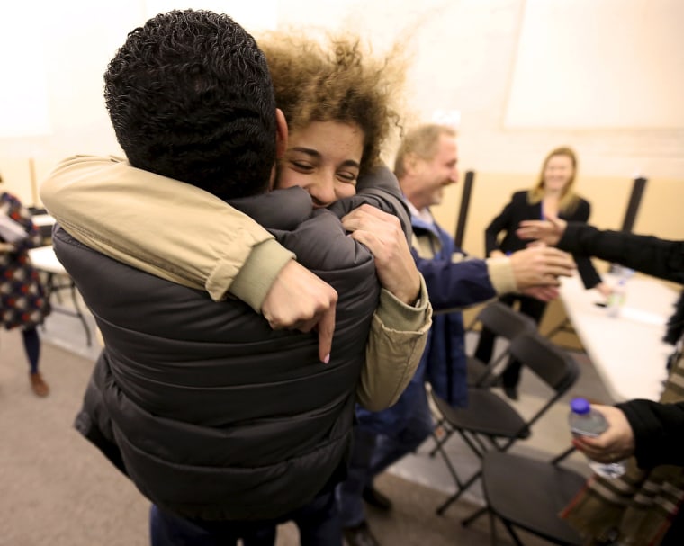 Image: Anas Francis is reunited with his cousin Syrian refugee Laila Beylouneh at the Welcome Centre in Montreal