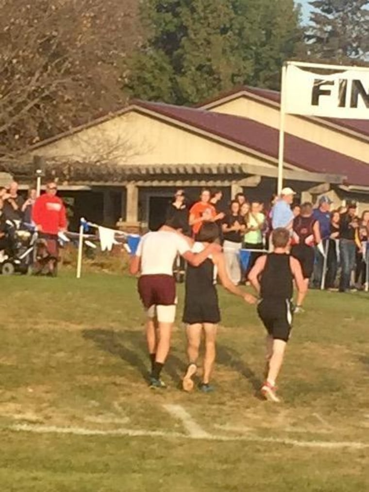 Although Davis County High School senior Zachary Hougland, in white, finished first in an Oct. 22 cross-country race, he was disqualified after he'd helped a struggling opponent across the finish line.