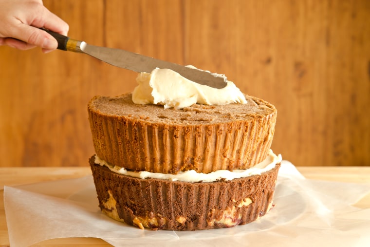 How to Make The Cherpumple Step-by-Step: Scoop 1 heaping cup of frosting onto the center of the pumpkin-pie-spice-cake layer and spread to the edges in a wide circular motion with a large icing spatula or knife
