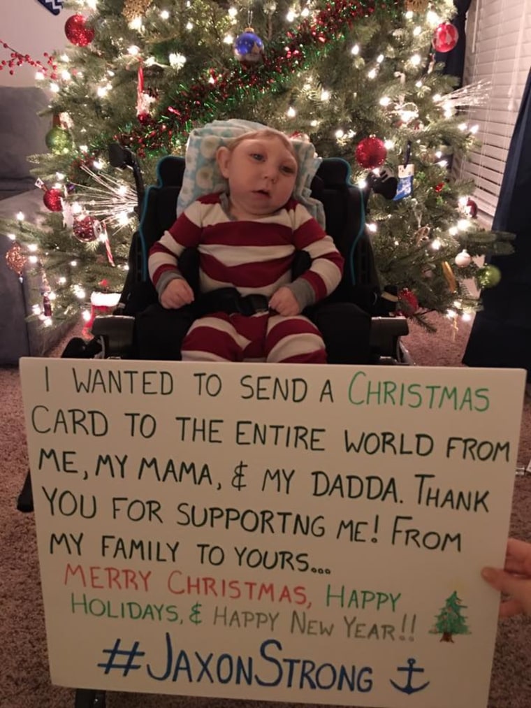 Jaxon poses with a Christmas card expressing thanks.