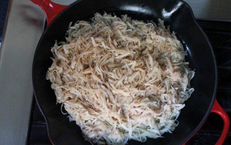 Crispy Rösti Potatoes with Oven-Poached Eggs: Place grated potatoes and onions in an olive oil-coated pan