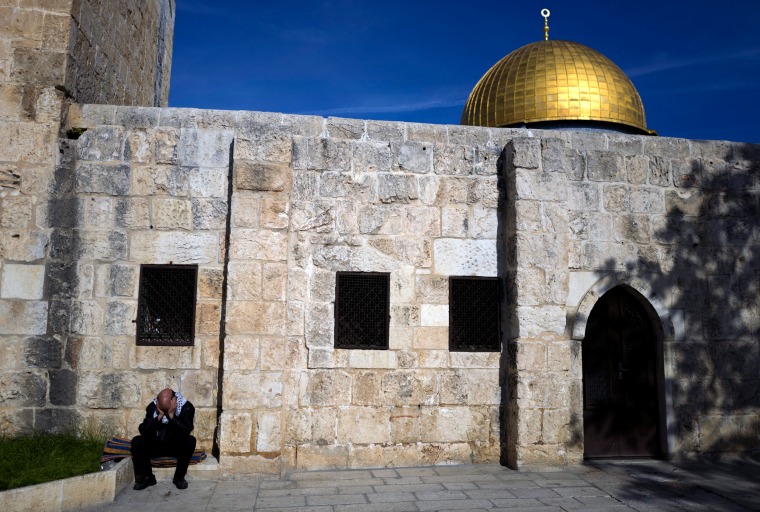 Image: A Muslim man sits outside the Harim el Sharif