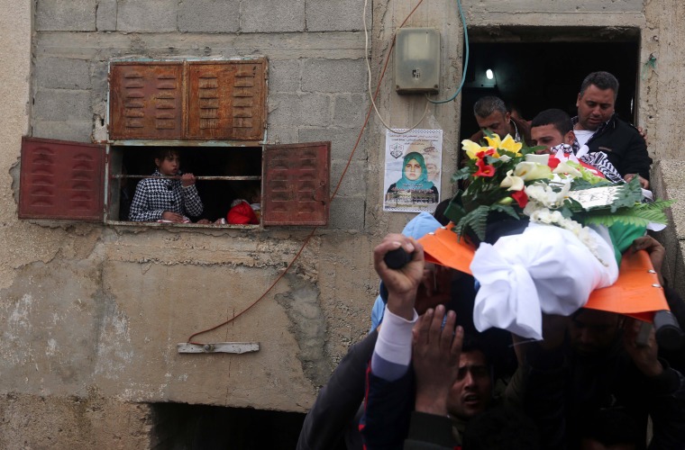 Image: Mourners carry the body of Palestinian woman Samah Abdullah