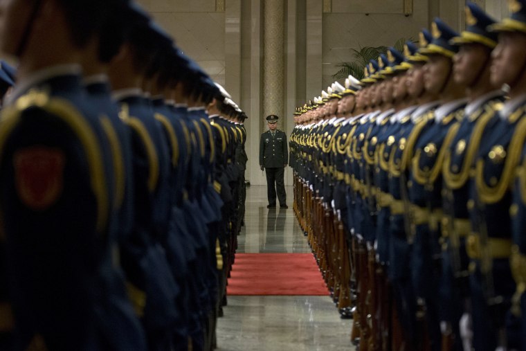 Image: Members of a Chinese honor guard prepare for a welcome ceremony for Russian Prime Minister Dmitry Medvedev