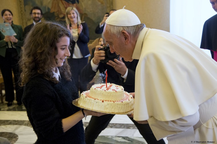Image: Pope Francis, whose 79th birthday is today, blows out a candle on a cake during a special audience with members of Italian Catholic Action movement at the Vatican