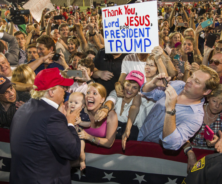 Image: Republican presidential candidate Donald Trump greets supporters